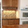 Stained maple cabinets with granite top and wine rack