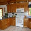 Oak raised panel doors with flat drawer fronts; laminate counters