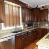 Dark stain on staggered height cherry kitchen cabinets 